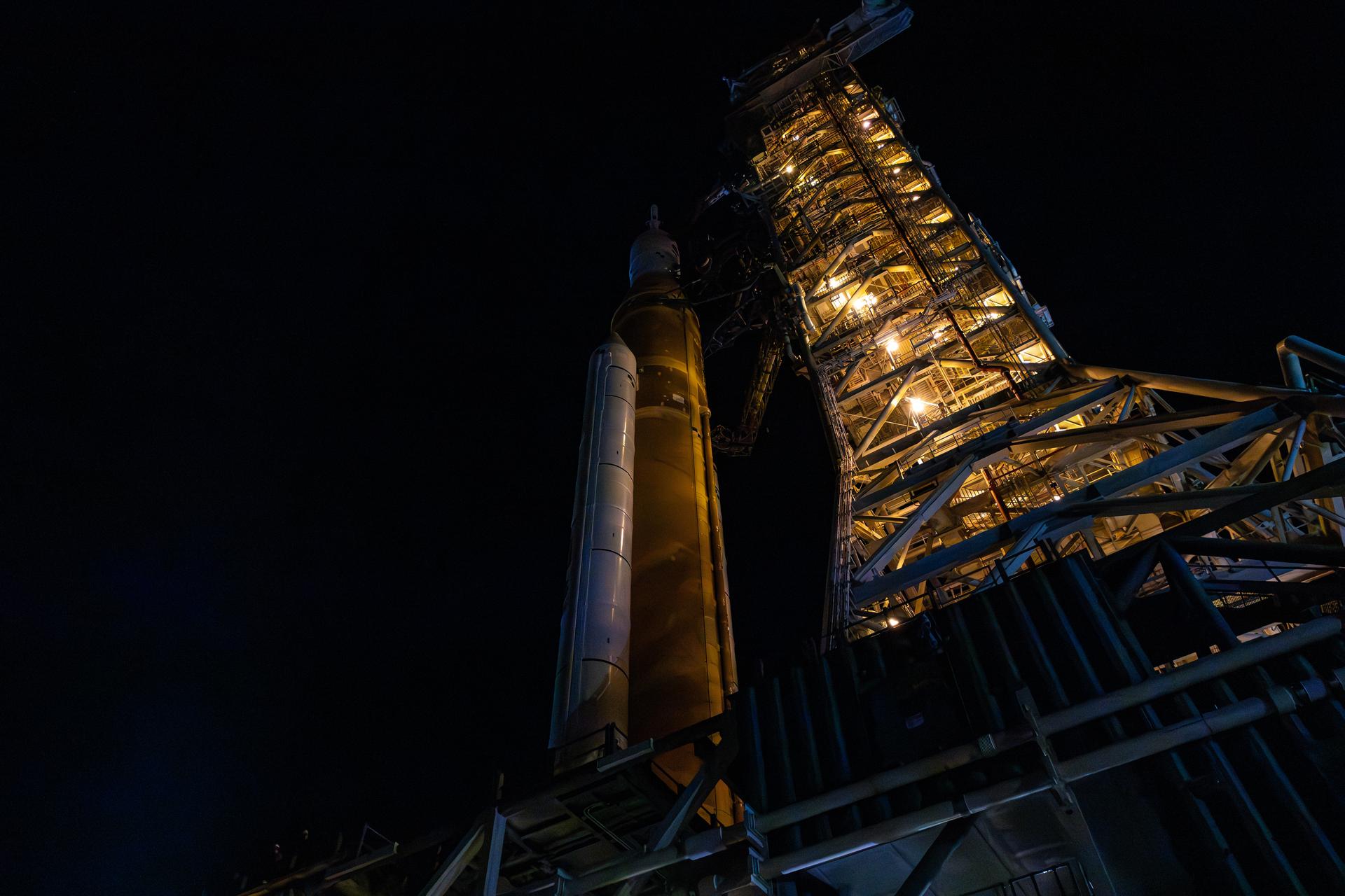 This image shows NASA’s SLS (Space Launch System) and Orion spacecraft rolling out of the Vehicle Assembly Building at NASA’s Kennedy Space Center. NASA's massive Crawler-Transporter, upgraded for the Artemis program, carries the powerful SLS rocket and Orion spacecraft on the Mobile Launcher from the Vehicle Assembly Building to Launch Pad 39B at Kennedy Space Center in preparation for the Artemis II mission.